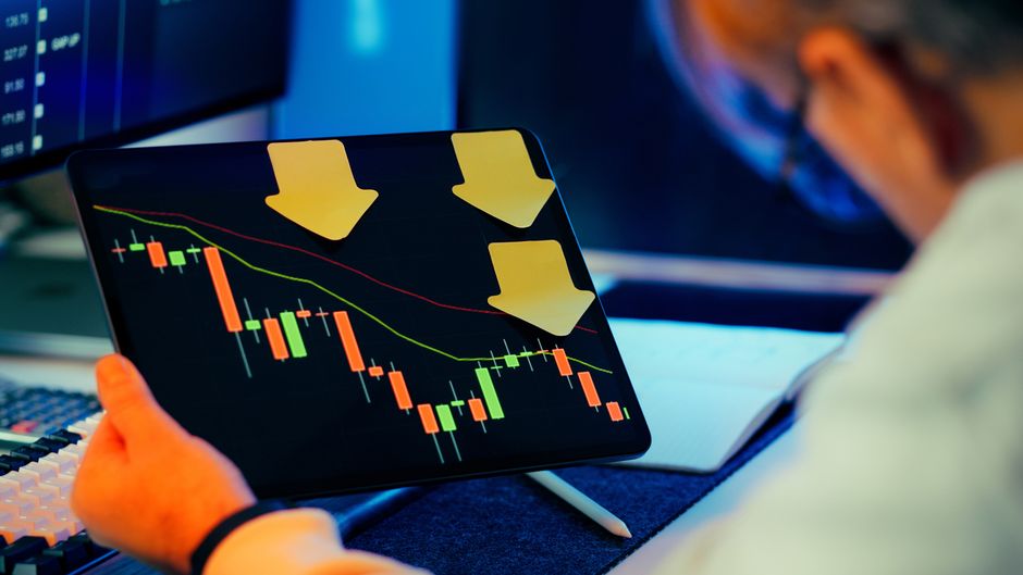 A sharply declining stock chart shown on a trading tablet (illustrative image)