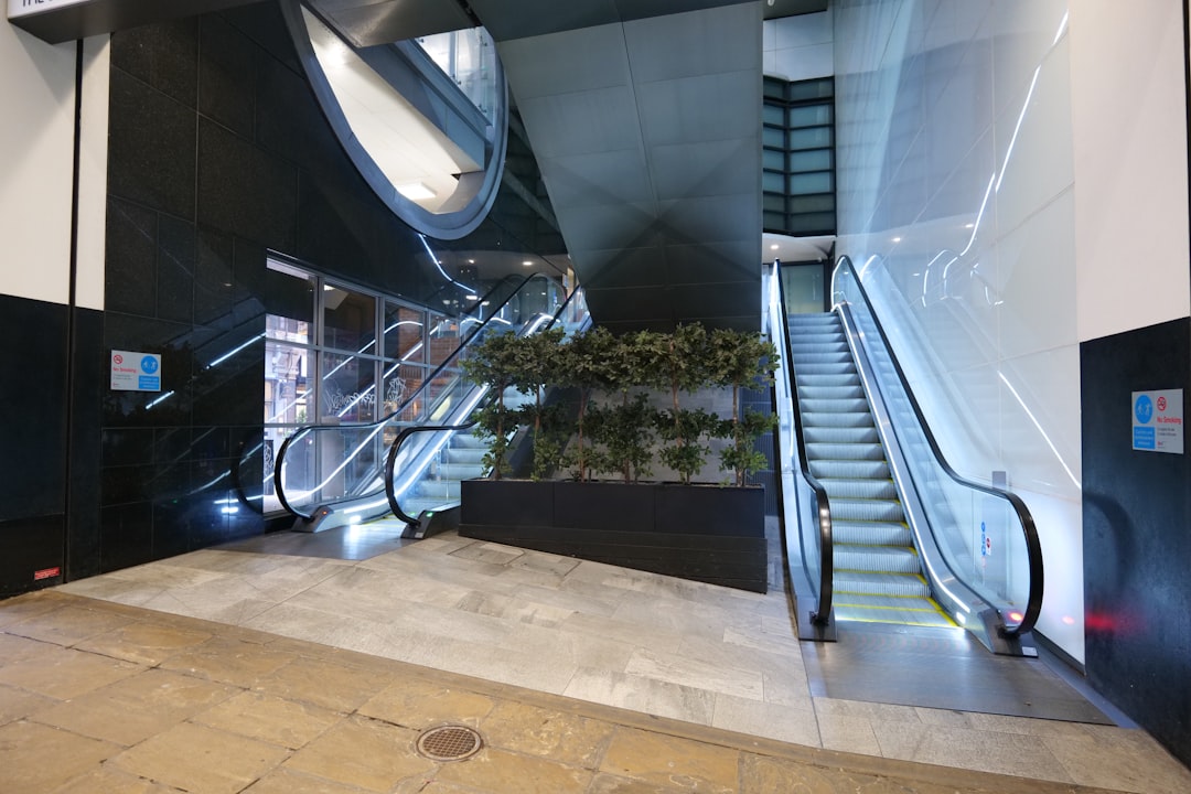 Escalators in an empty retail hall with no shoppers in frame