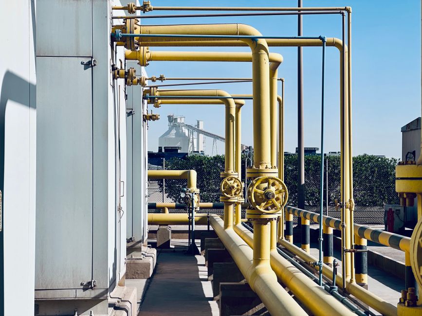Industrial piping and valve manifolds illustrating the refining and petrochemical analysis