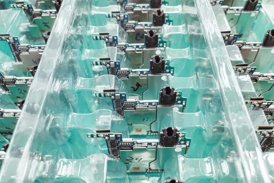 Simmtech stock analysis image: circuit boards on an electronics production line