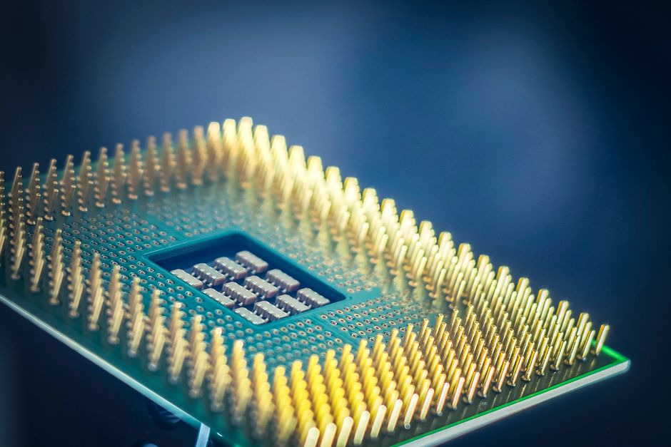 Close-up of a semiconductor package substrate with gold pins, the product category behind the Simmtech stock argument