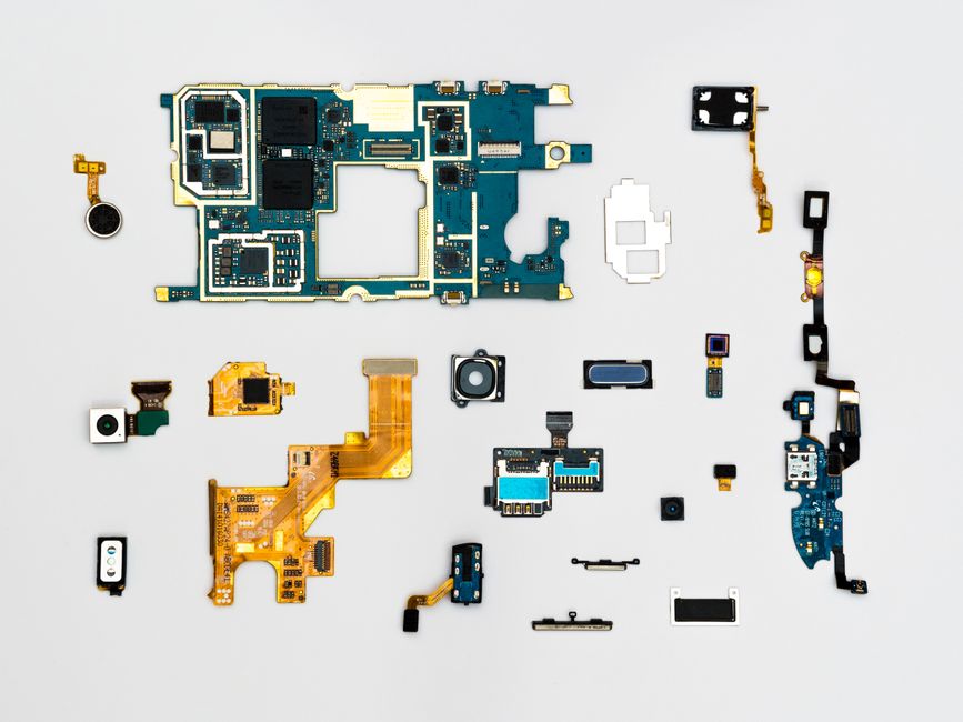 Disassembled handset components including flexible printed circuits laid out flat