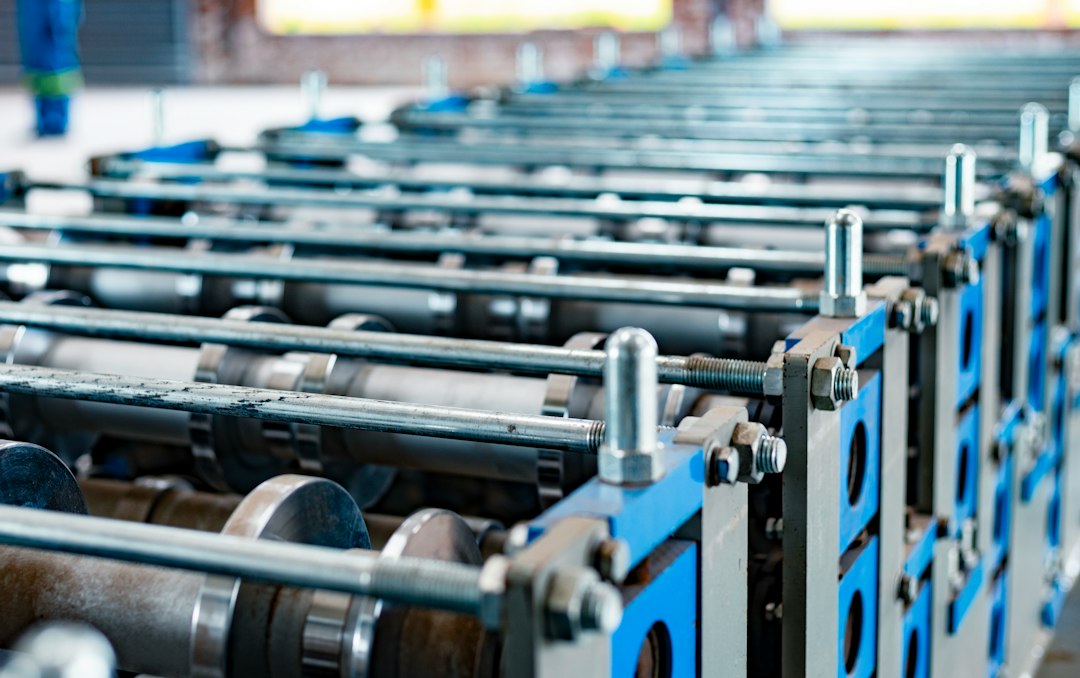 Roll forming machinery on a plant floor, the kind of equipment used to shape spring steel