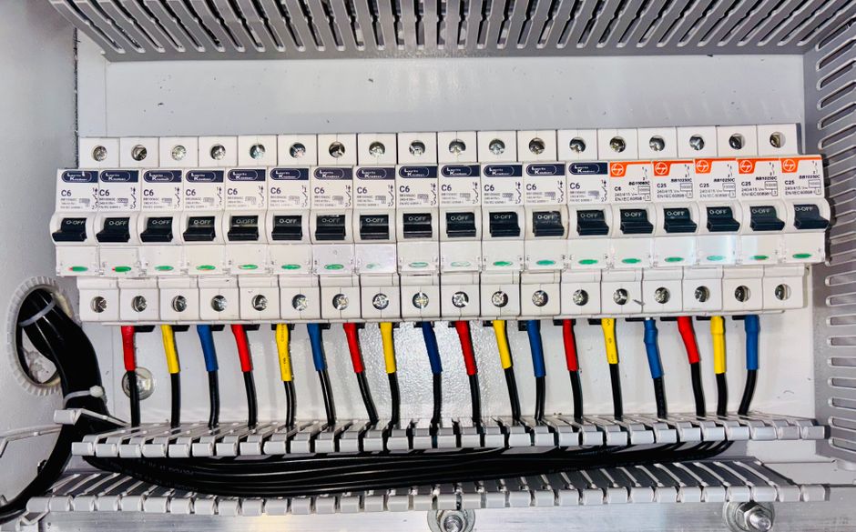 Circuit breakers and wiring trunking inside a distribution board, power distribution hardware relevant to Gaon Cable stock