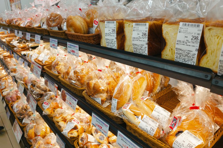 A convenience-store shelf of packaged bread and ready-made food