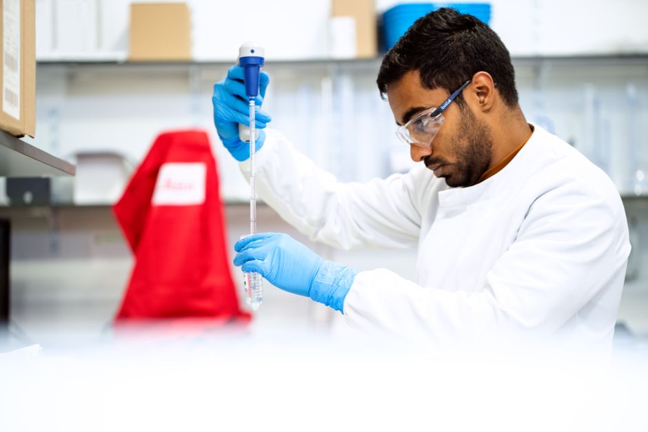 Laboratory bench work standing in for the research pipeline behind the licensing deals