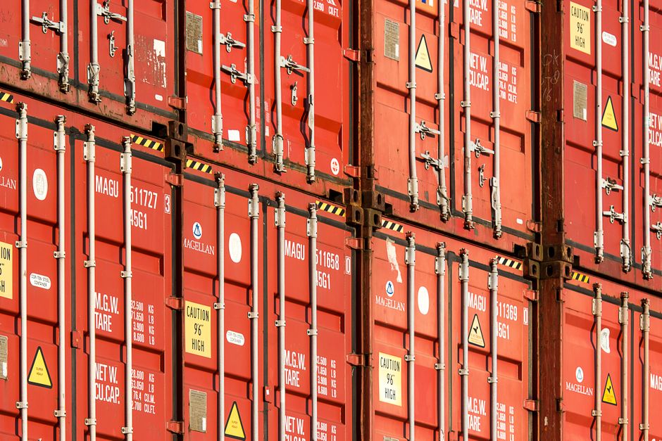 Stacked shipping containers behind the Hyundai Corporation stock trading business