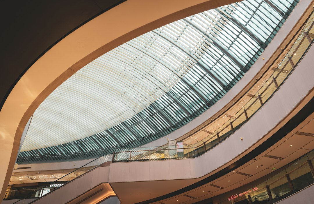 Hyundai Department Store stock write-up illustrated with a wide retail atrium and escalators