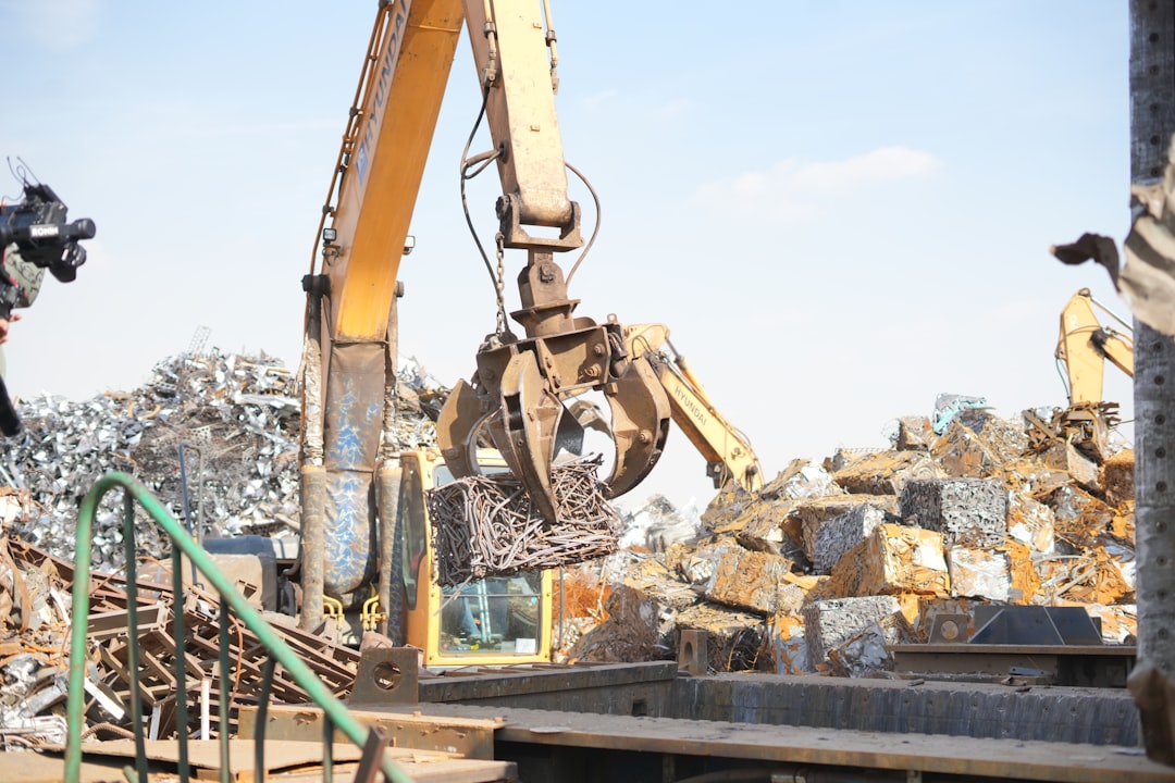 Scrap sorting yard with a grapple excavator, for Insun ENT stock analysis