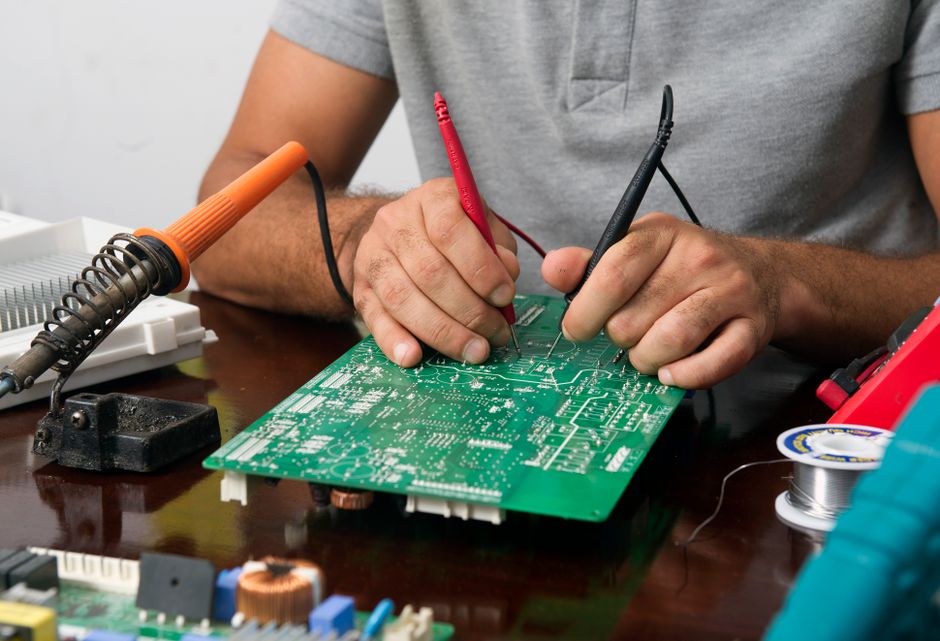 Test probes making contact with a circuit board during electrical testing