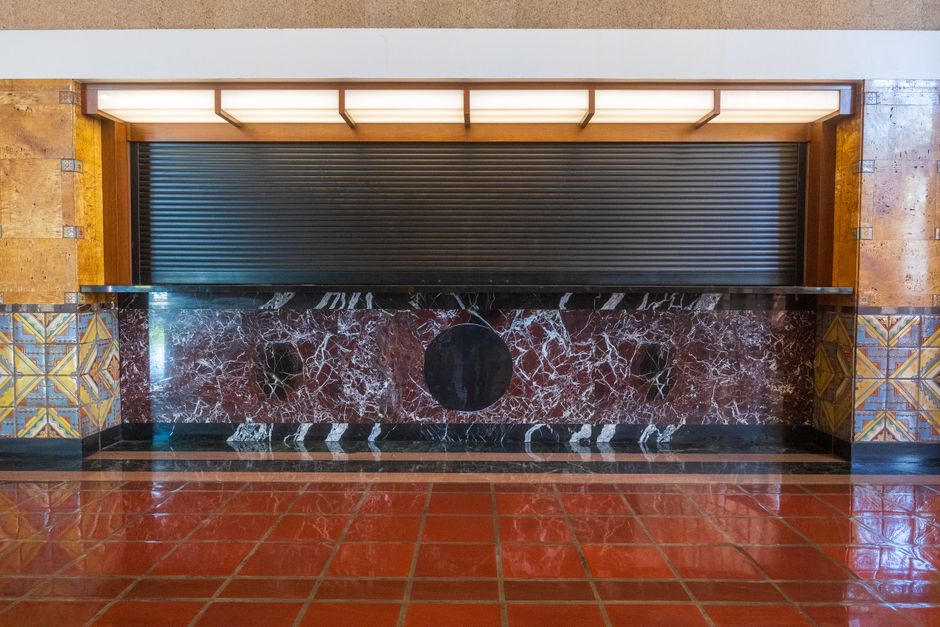 A bank teller counter in a branch interior with no visible signage