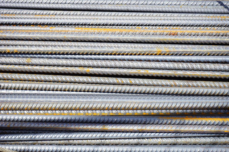 KISCO Holdings stock and a yard of stacked steel rebar bundles