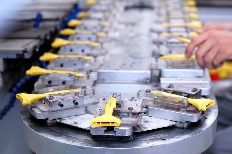 PHA stock and clamping jigs lined up on a parts production line