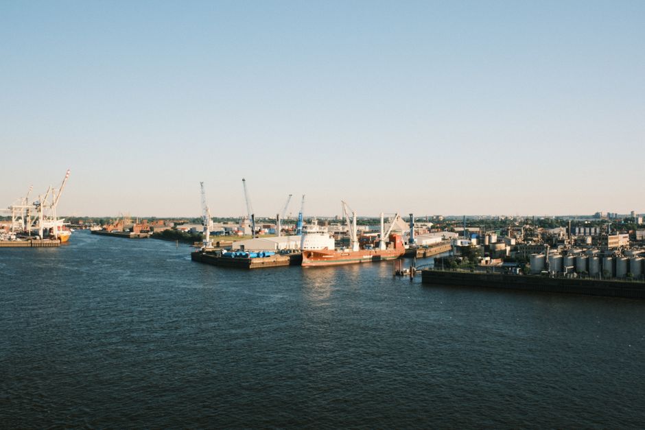 Wide view of a general cargo vessel berthed at an industrial quay