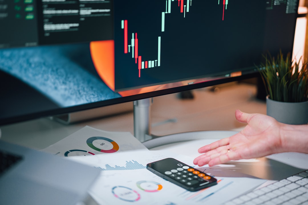 Printed financial reports and a market screen on one desk, the funding cost behind Samsung Card stock