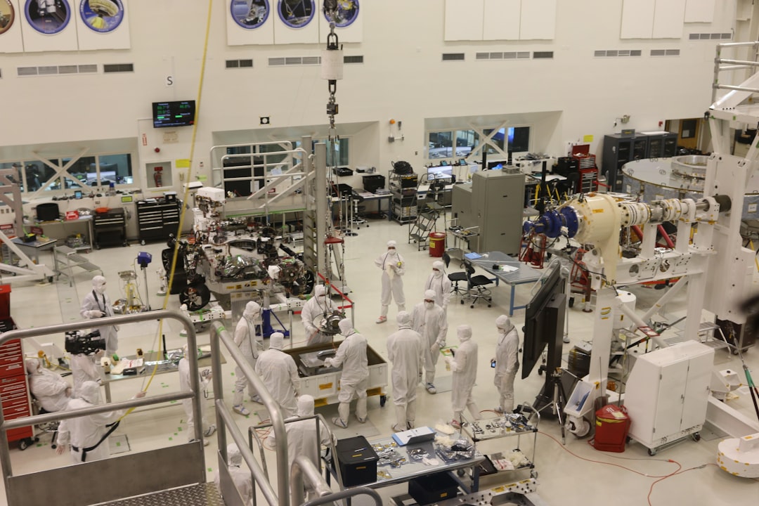 Satrec Initiative stock analysis alongside spacecraft assembly cleanroom work